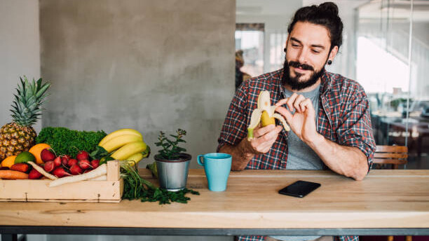 Na slici je prikazan čovek koji jede bananu, uz ostalo voće. Kao dobar izvor ugljenih hidrata.